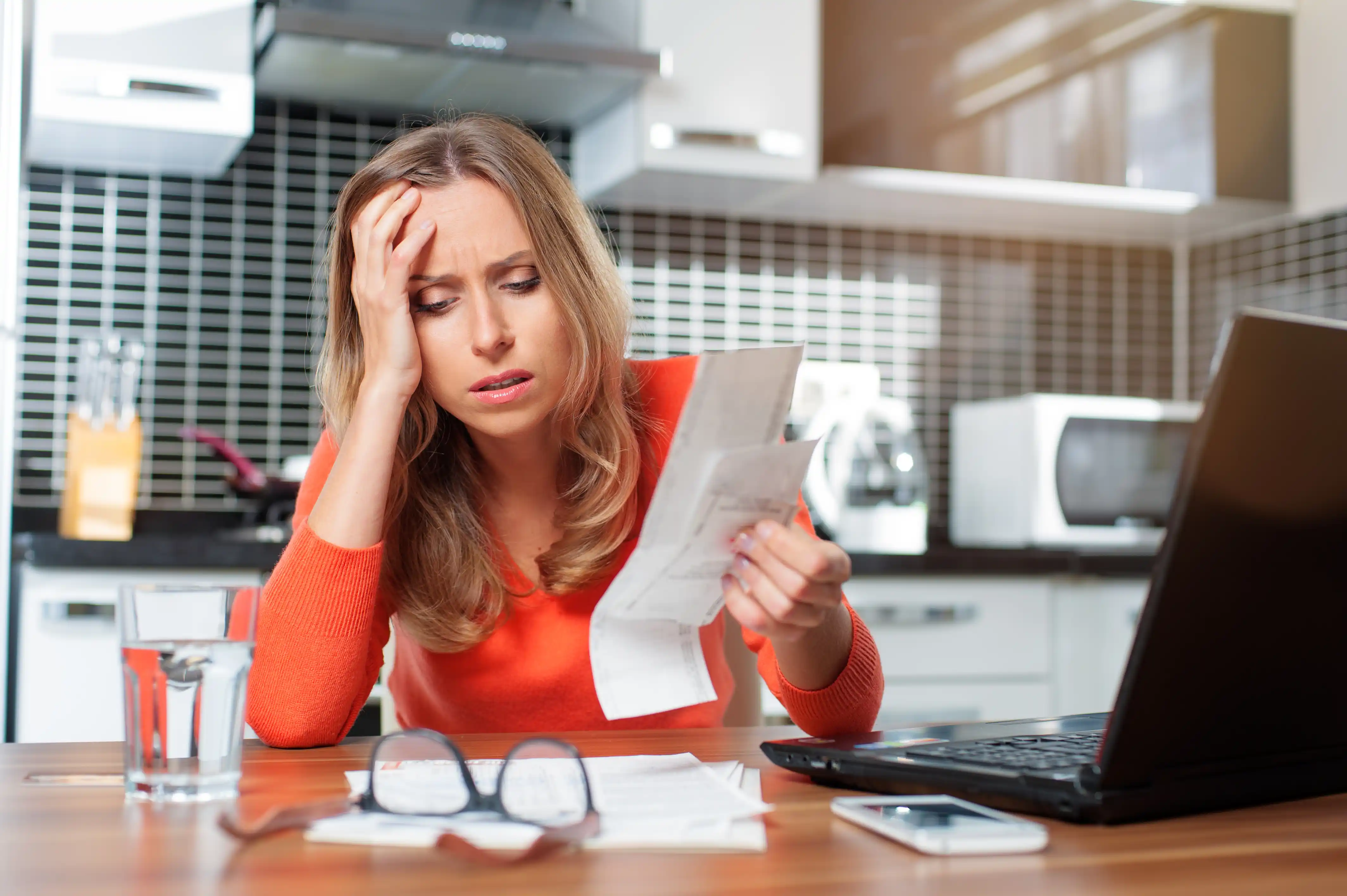 young woman buried in debt