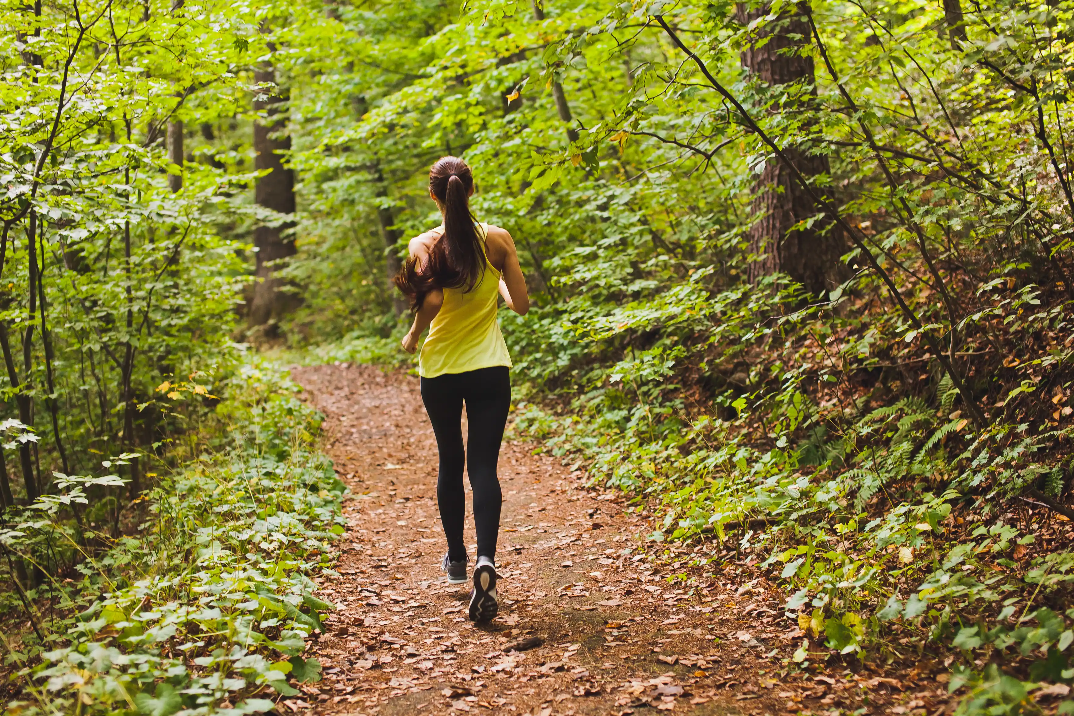 young woman running on a trail