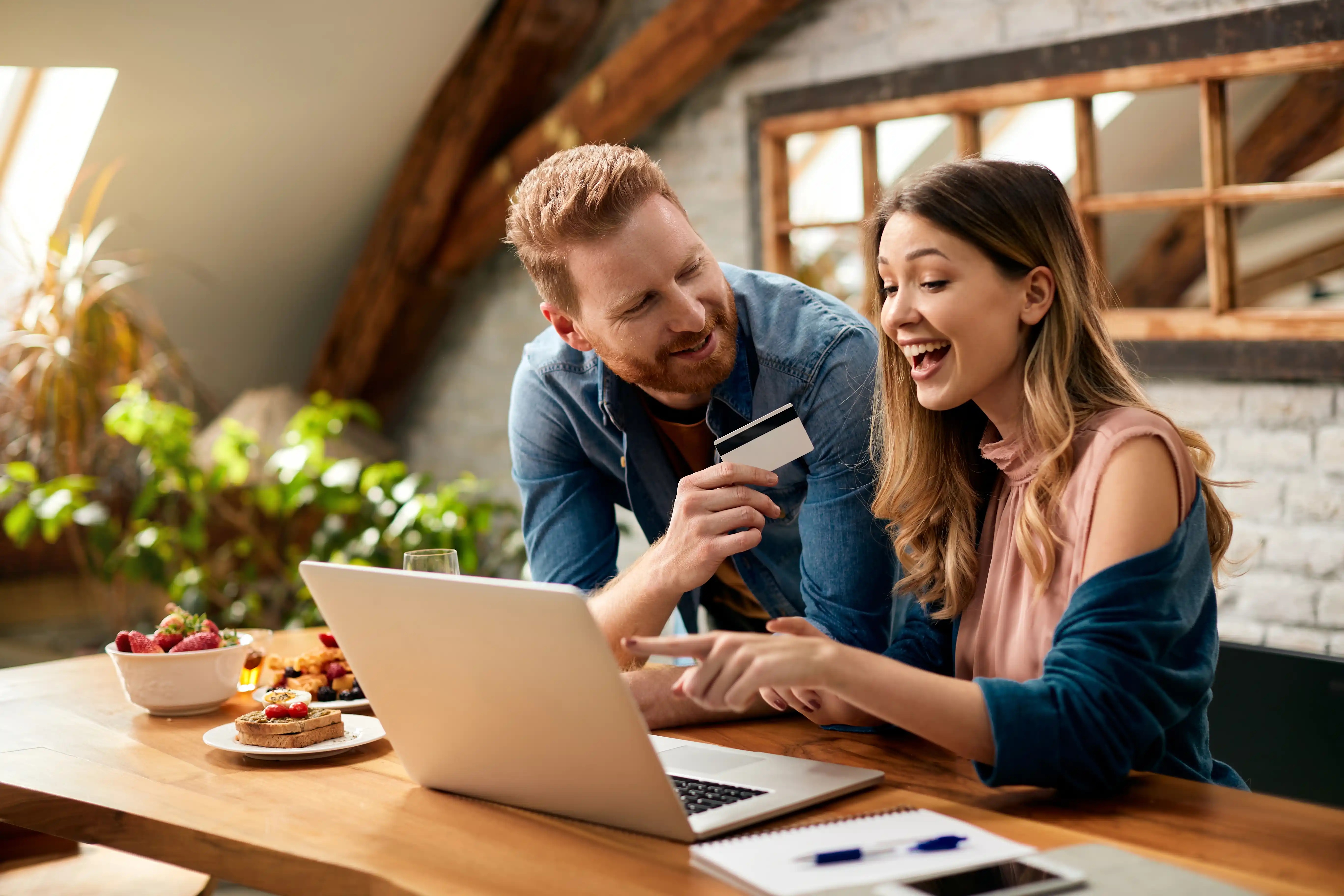 Young couple celebrating financial wins