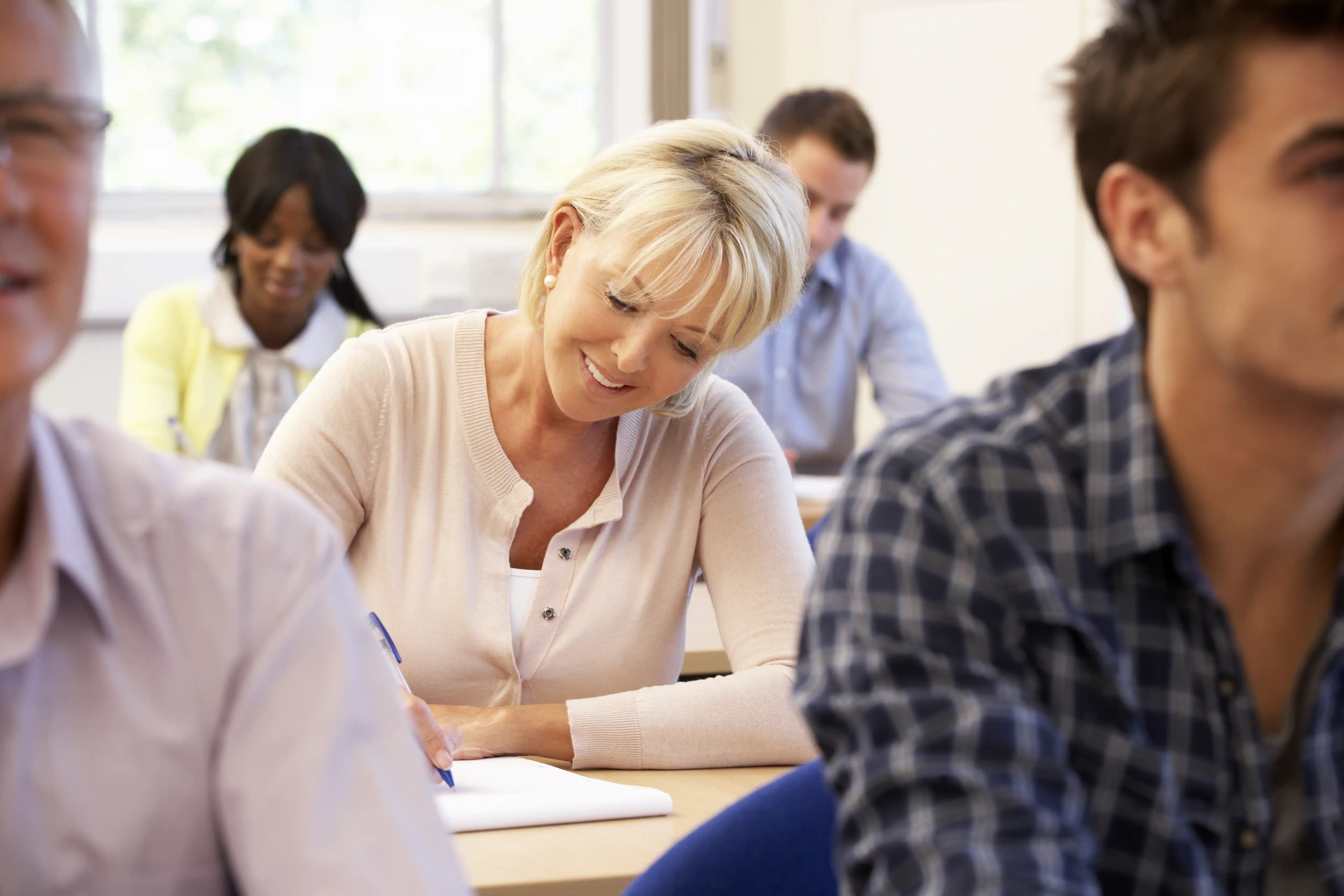 Middle-aged woman attending college class